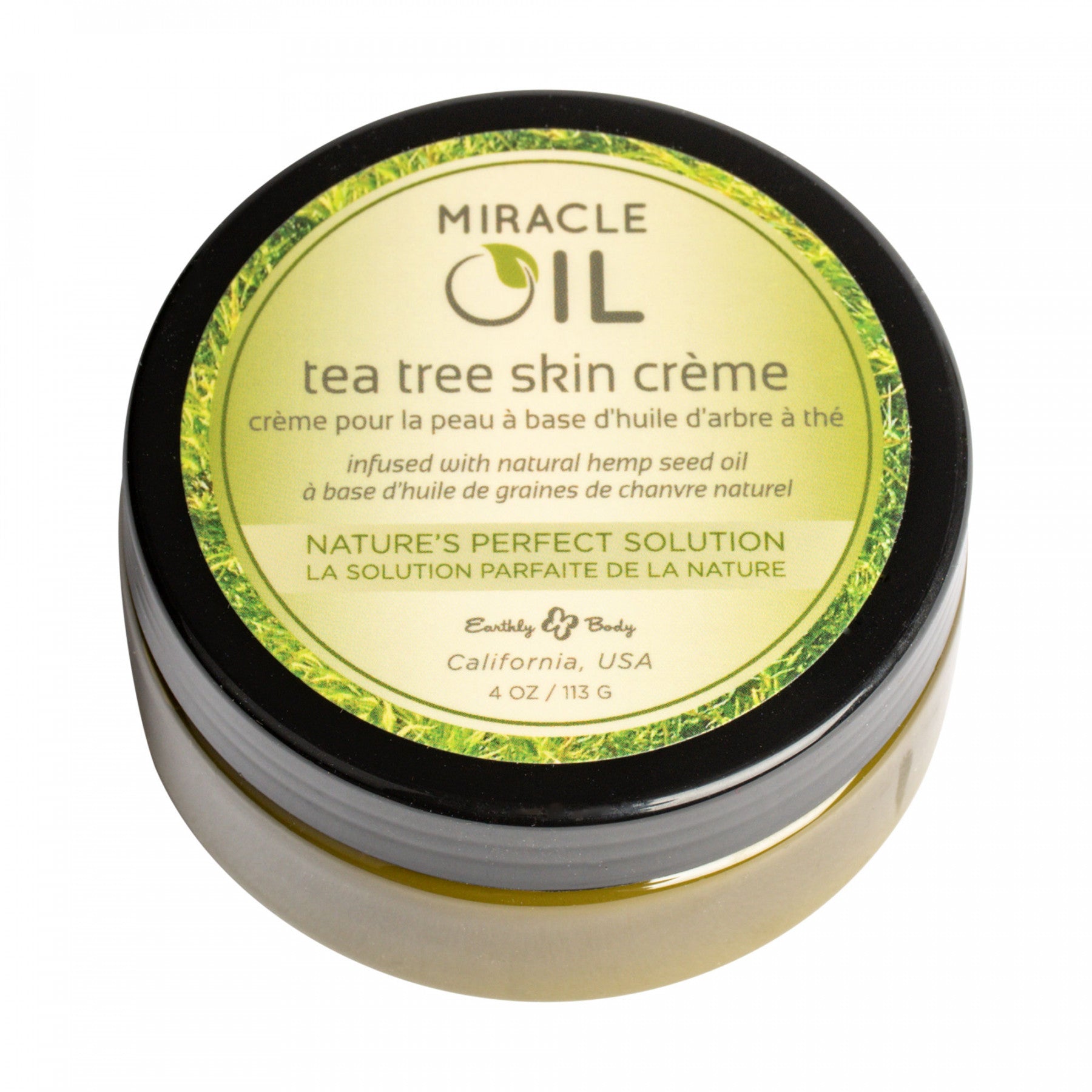 Round container with green label for Miracle Oil Tea Tree Skin Creme